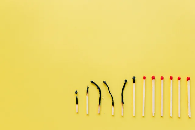 A row of burnt and unburnt matchsticks on a vibrant yellow background illustrating contrast. Matching landing-page content to query intent